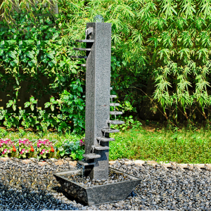 Granite tier stone flow water fountain in garden