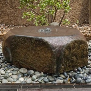 Lively Courtyard Ambiance with Basalt Fountain Create an Invigorating Garden Scene