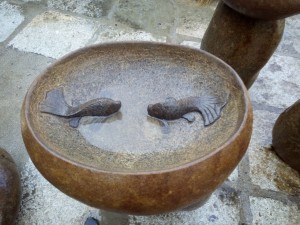 Boulder stone birdbath with fish statue