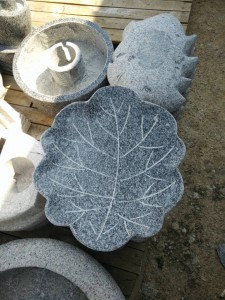 Round granite birdbath with bird statue decor