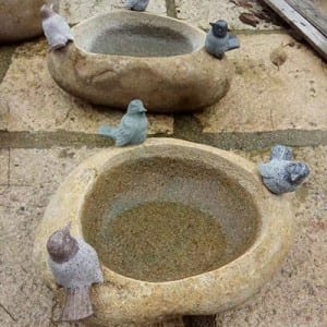 Boulder birdbath with bird statue decor