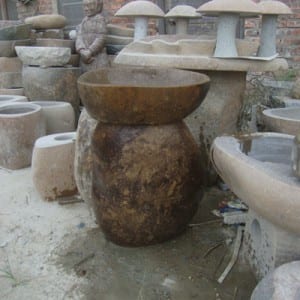 Boulder birdbath on the stand with fish statue