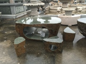 Granite table and curved chairs set outdoor for park