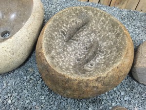 Boulder stone birdbath with fish statue