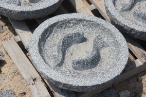 Round granite birdbath with fish