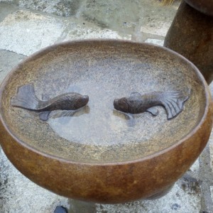 Boulder stone birdbath with fish statue