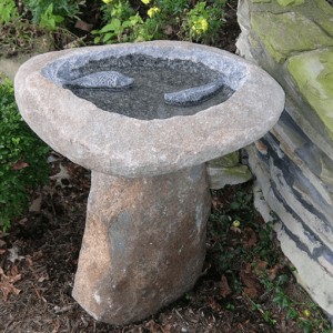 Boulder birdbath on the stand with fish statue