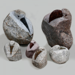 Different size rock pelican statues