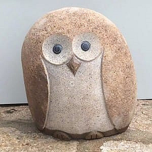 Decorative cobble stone owls statues