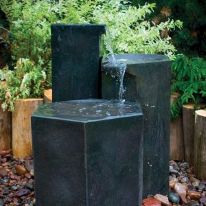 Formal basalt column set fountain