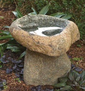 Boulder birdbath on the stand with fish statue