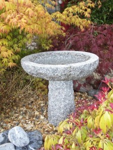 Round granite stone birdbath on stand