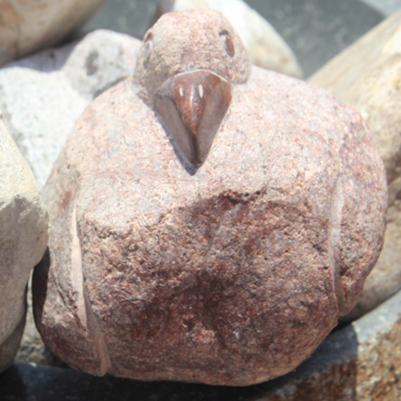 red boulder pelican carving