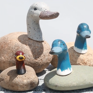 Rock boulder carving duck statue